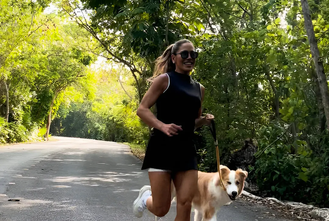 A runner with her dog on the development's trail circuit